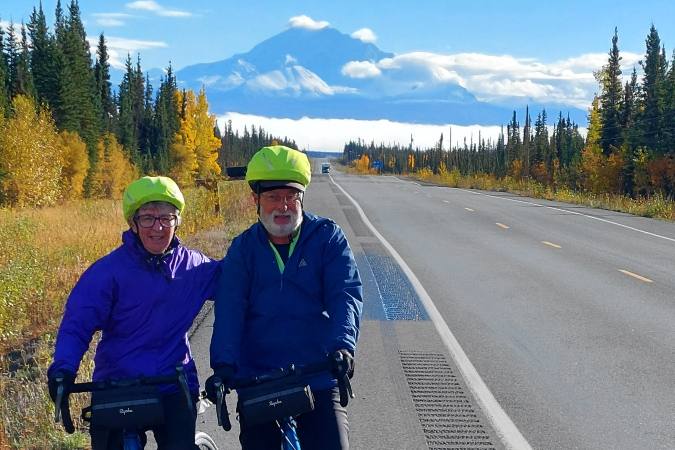 bicyclists in Matanuska Valley Wrangell volcano behind