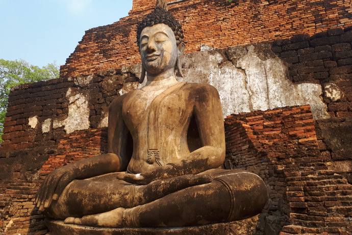 buddha statue in front of stupha