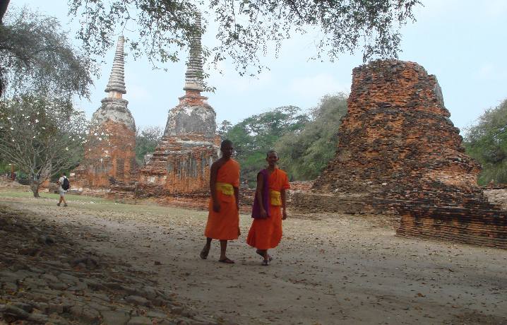 monks walking through ruins in Ayutthaya