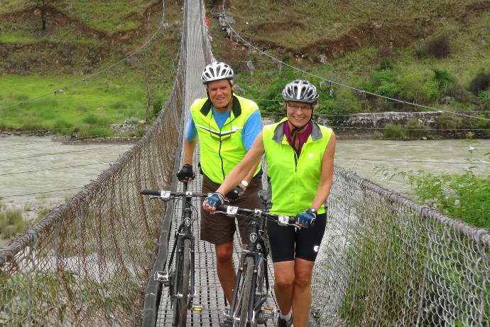 two bicyclists on suspension bridge