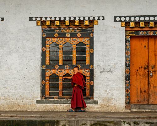 young monk in front of dzong temple