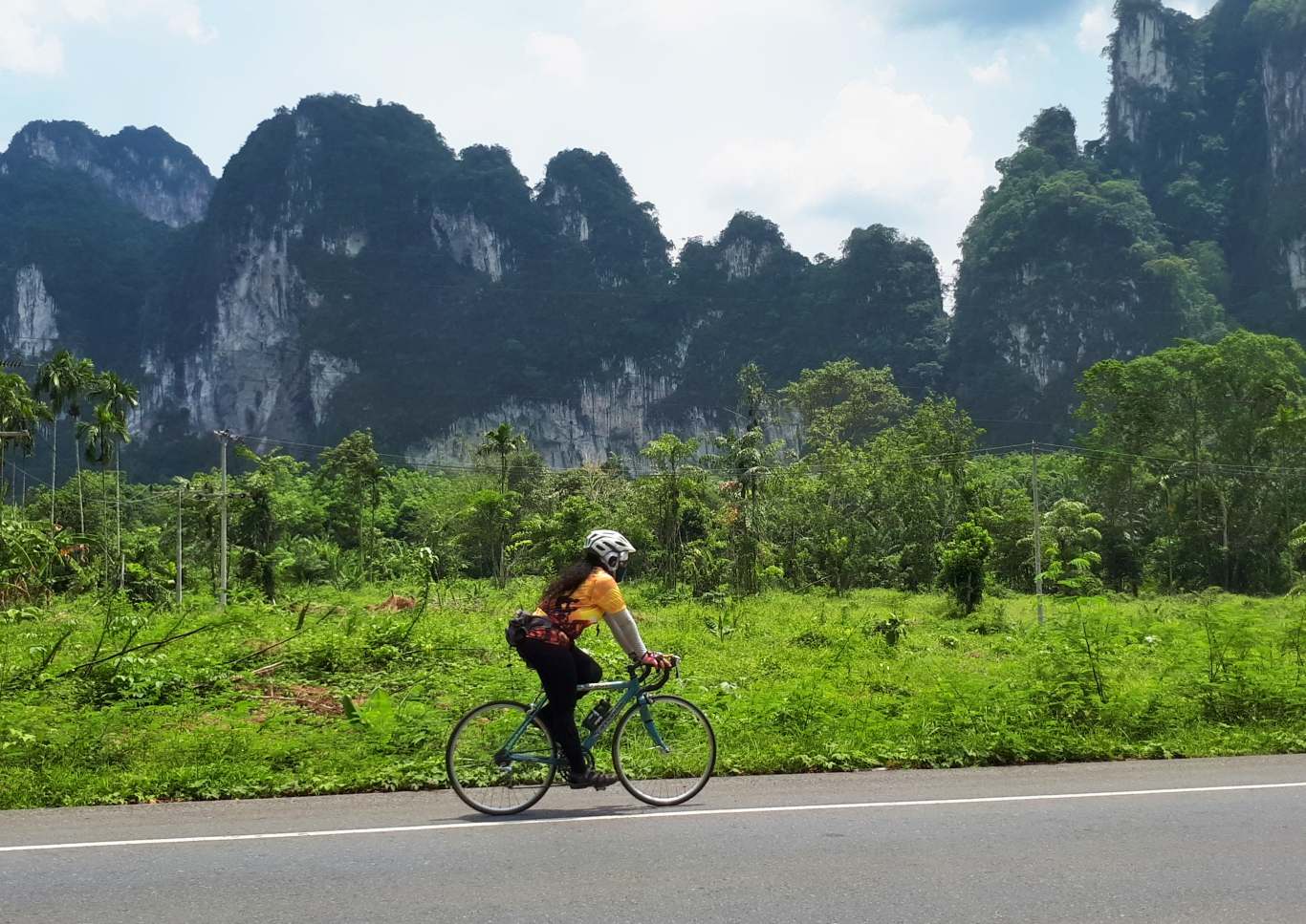 cyclist riding past karst outcroppings
