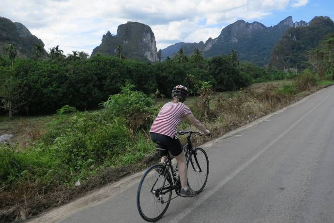 bicyclist passing karst outcroppings