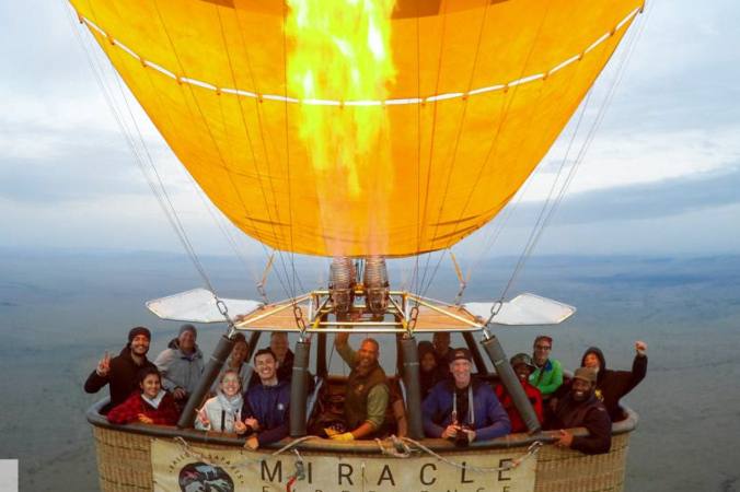 bicycle club members hot air ballooning Serengeti plains