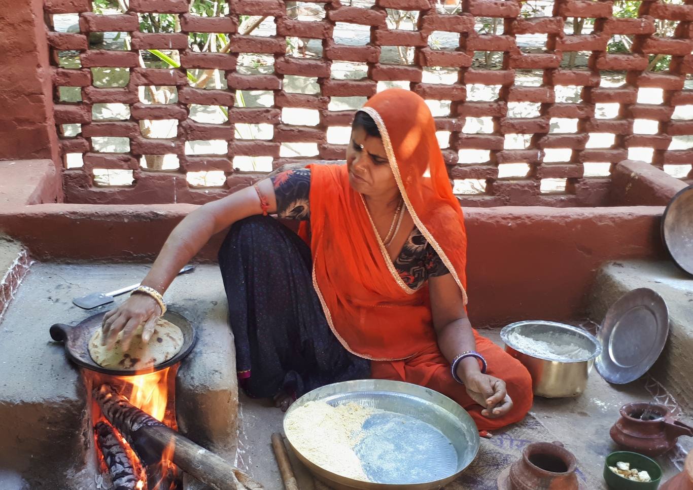 Lady cooking rajasthan cusine over open fire