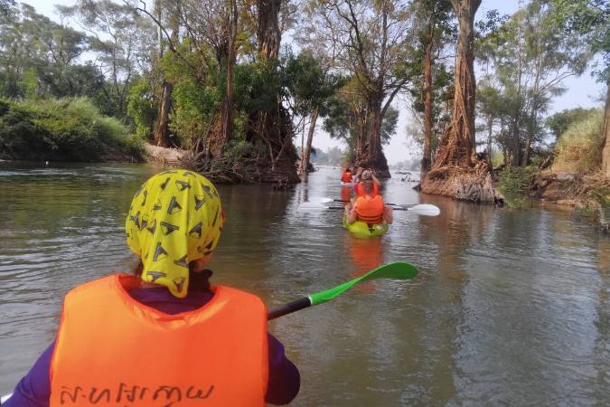 canoeing along narrow section of Mekong