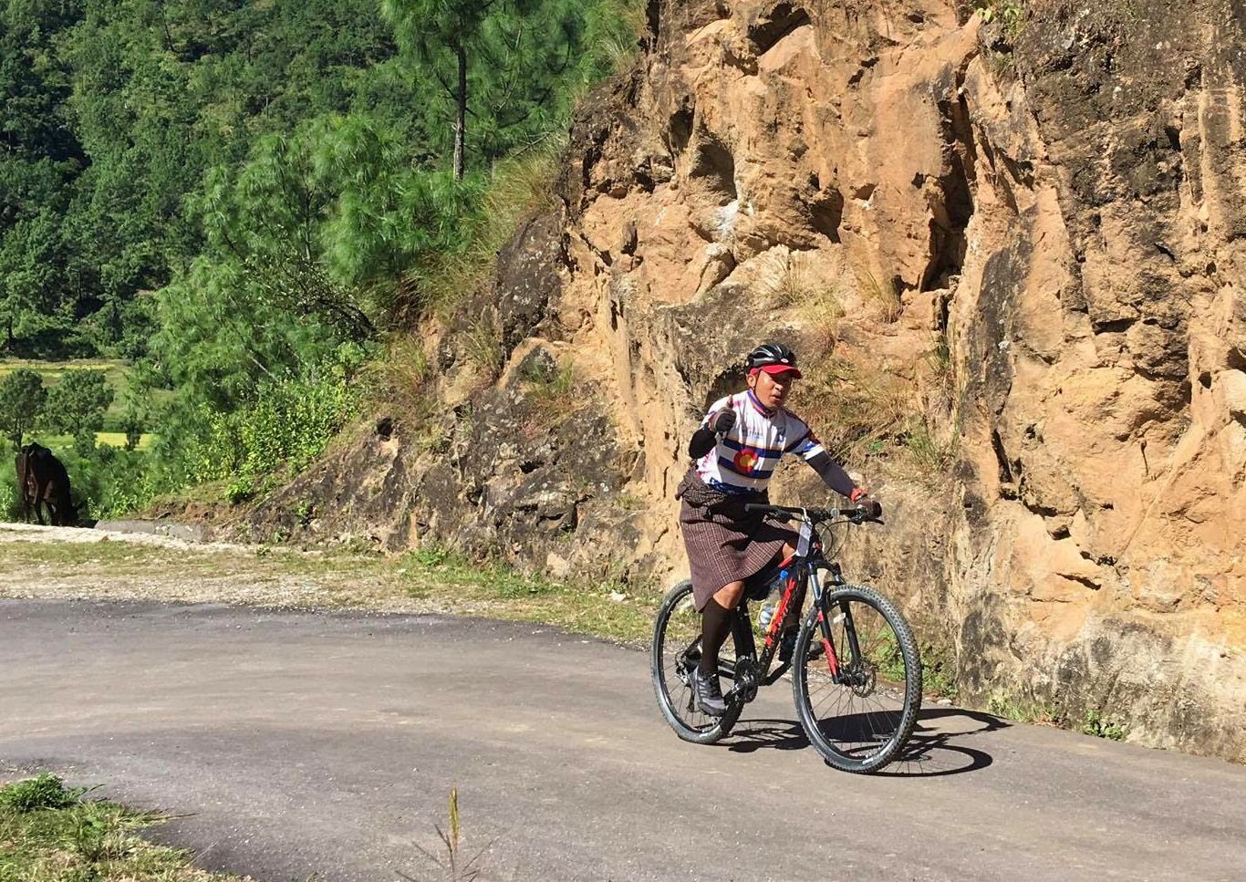 Bhutan bike guide in traditional clothes