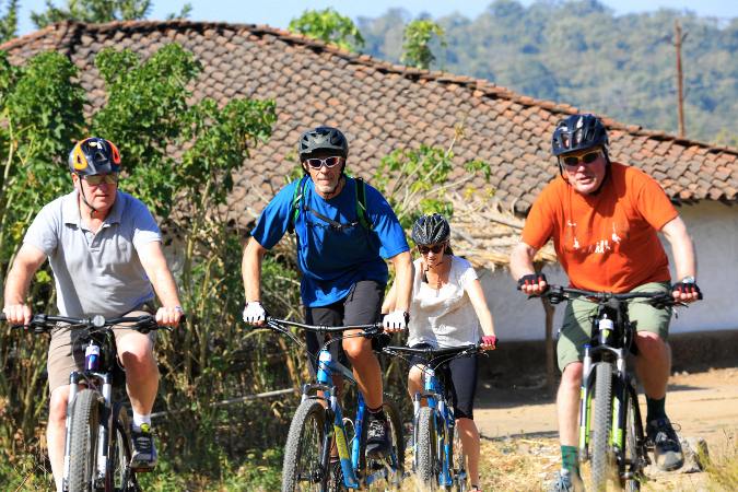 bicyclists in tribal village