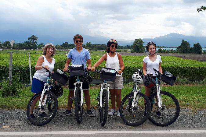 bicyclists in front of vegetable farm