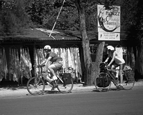 cyclists passing shop in Moorea